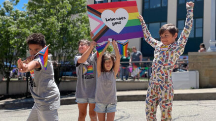 Children at our inaugural Lebo Pride Celebration holding up a sign facing protestors.